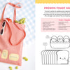 A pink tote with kawaii bread and butter embroidery from "Stitching Super-Cute Food Kawaii Style" by Schiffer Publishing, Ltd. sits on blue checks, holding a baguette and fruit beside beginner-friendly embroidery instructions.