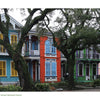 Colorful historic homes with ornate balconies and lush greenery line Esplanade Avenue in the Creole Garden District—scenes featured in "New Orleans" by Schiffer Publishing, Ltd.