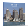 Detroit by Schiffer Publishing, Ltd. is a Detroit photo book featuring downtown skyscrapers and two boats on the river—a perfect Motor City souvenir.