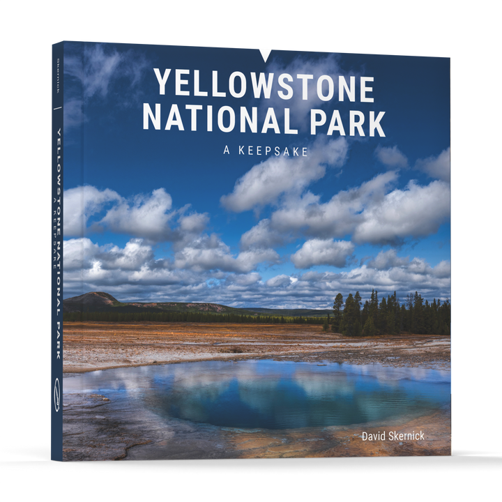 Yellowstone National Park by Schiffer Publishing, Ltd. features a vibrant hot spring, cloudy sky, and trees on the cover, celebrating the geothermal wonders of Yellowstone National Park.