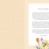 A copy of “MindfulMoments Word Search Inspired Living” by Schiffer Publishing, Ltd. lies open to a welcoming message on the right page, surrounded by pressed flowers, wrapped gifts, and dried lavender along the bottom edge, all set against a soft beige background featuring a checkered pattern on the left side.