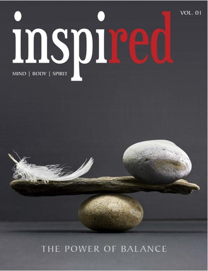 Magazine cover titled inspired with red in red font. Image shows a feather and stone balanced on a wooden stick over a rock. Text: MIND | BODY | SPIRIT and THE POWER OF BALANCE. Background is gray.
