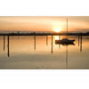 A small sailboat rests on calm water at sunset near Martha’s Vineyard, its reflection shimmering, as captured in "Martha’s Vineyard Wide" by Schiffer Publishing, Ltd., with warm light and wooden posts completing the tranquil scene.