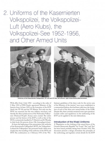 Four men stand for a group photo in front of a plain background. Three wear East German military uniforms with caps and medals, while one wears a pilot’s helmet and leather jacket, as featured in "Uniforms of the East German Military" by Schiffer Publishing, Ltd.