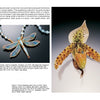 A page from "Art Jewelry Today 2" by Schiffer Publishing, Ltd. displays a dragonfly necklace with blue-gold wings and a lifelike speckled orchid sculpture, each labeled with the artist’s name and materials used.